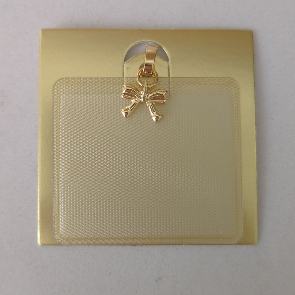 Gold bow charm